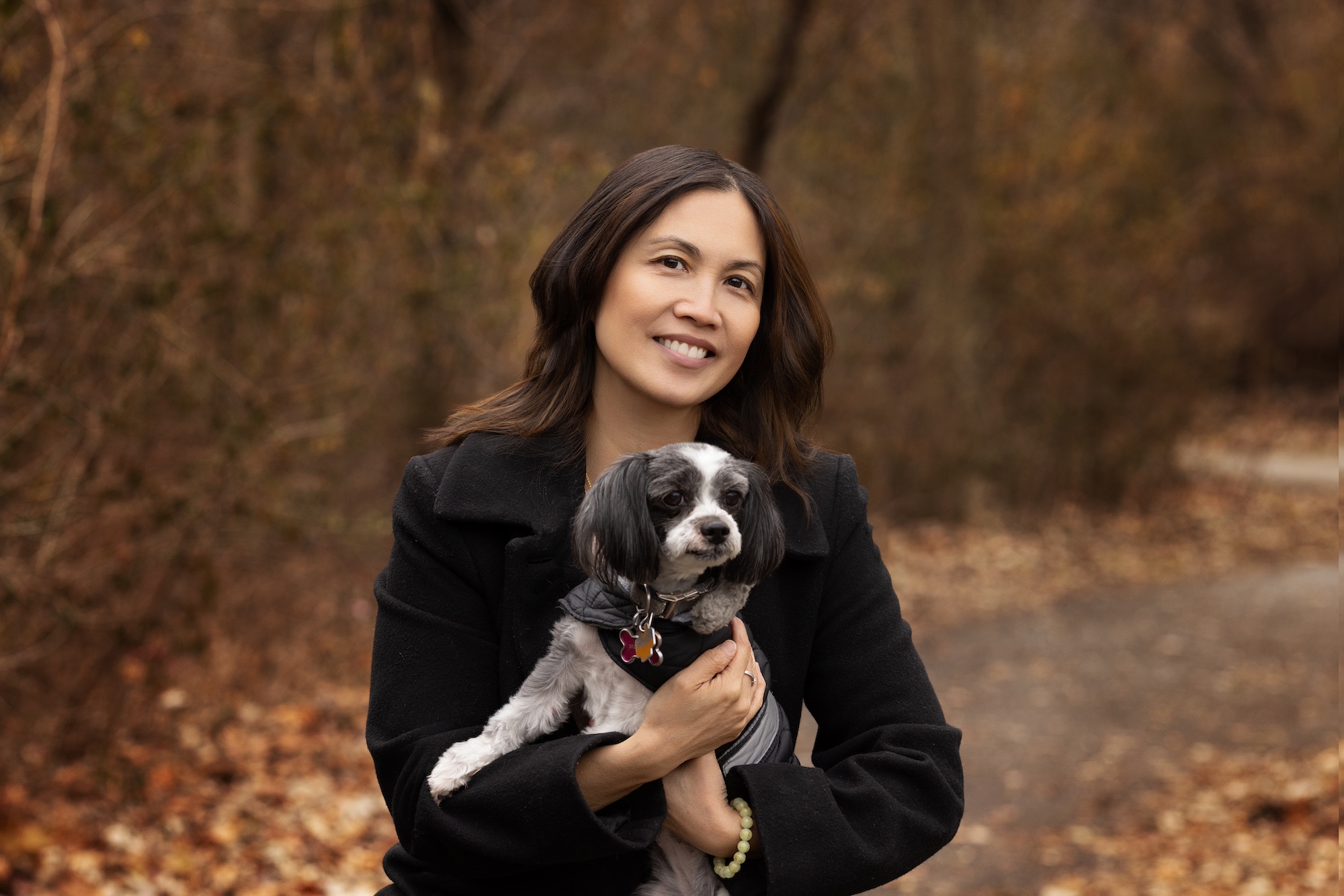 mother holding her dog at a chicago outdoor photography fall session