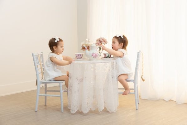 image of twin girls at a light and airy tea party