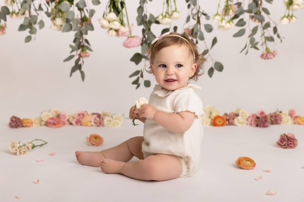 one year old girl smiling in a chicago studio