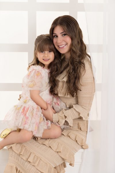 Mother and daughter sitting on a white windowsill in a Chicago studio