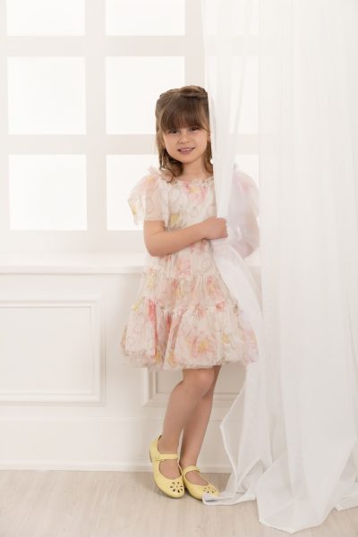 girl posing by a white window in a chicago studio