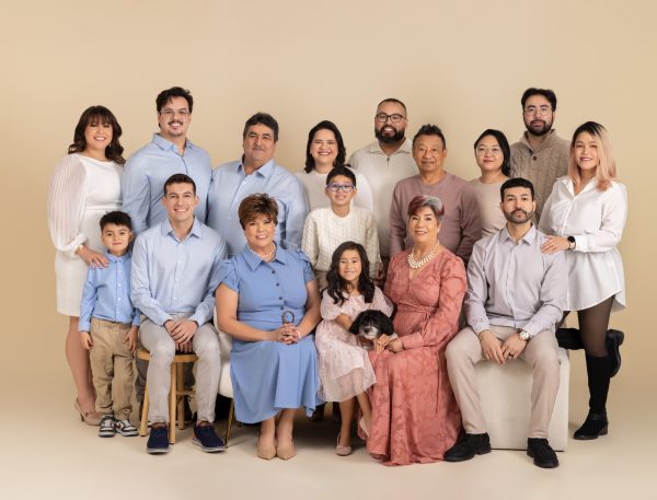 Generational family session portait featuring grandparents and their children, grandchildren and dog on a cream backdrop in a Chicago studio