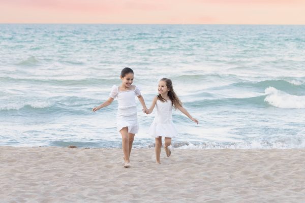 Girls running at sunset beach session