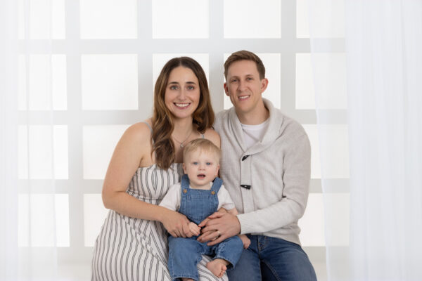 first birthday family portrait sitting in white window in Chicago studio