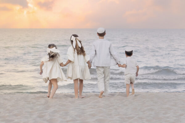 Family running during a beach session at Gillson Beach