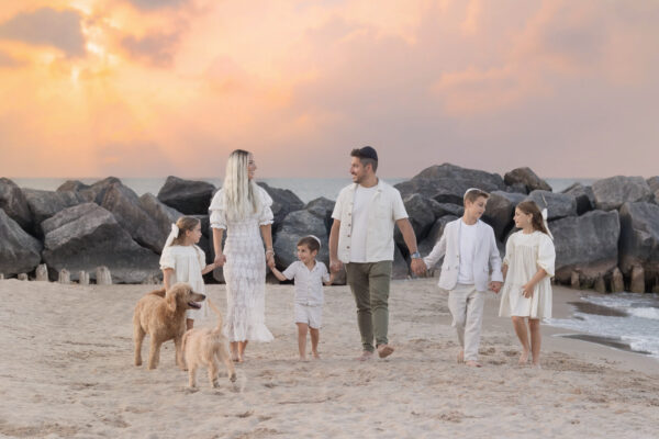 family strolling at a sunset beach session