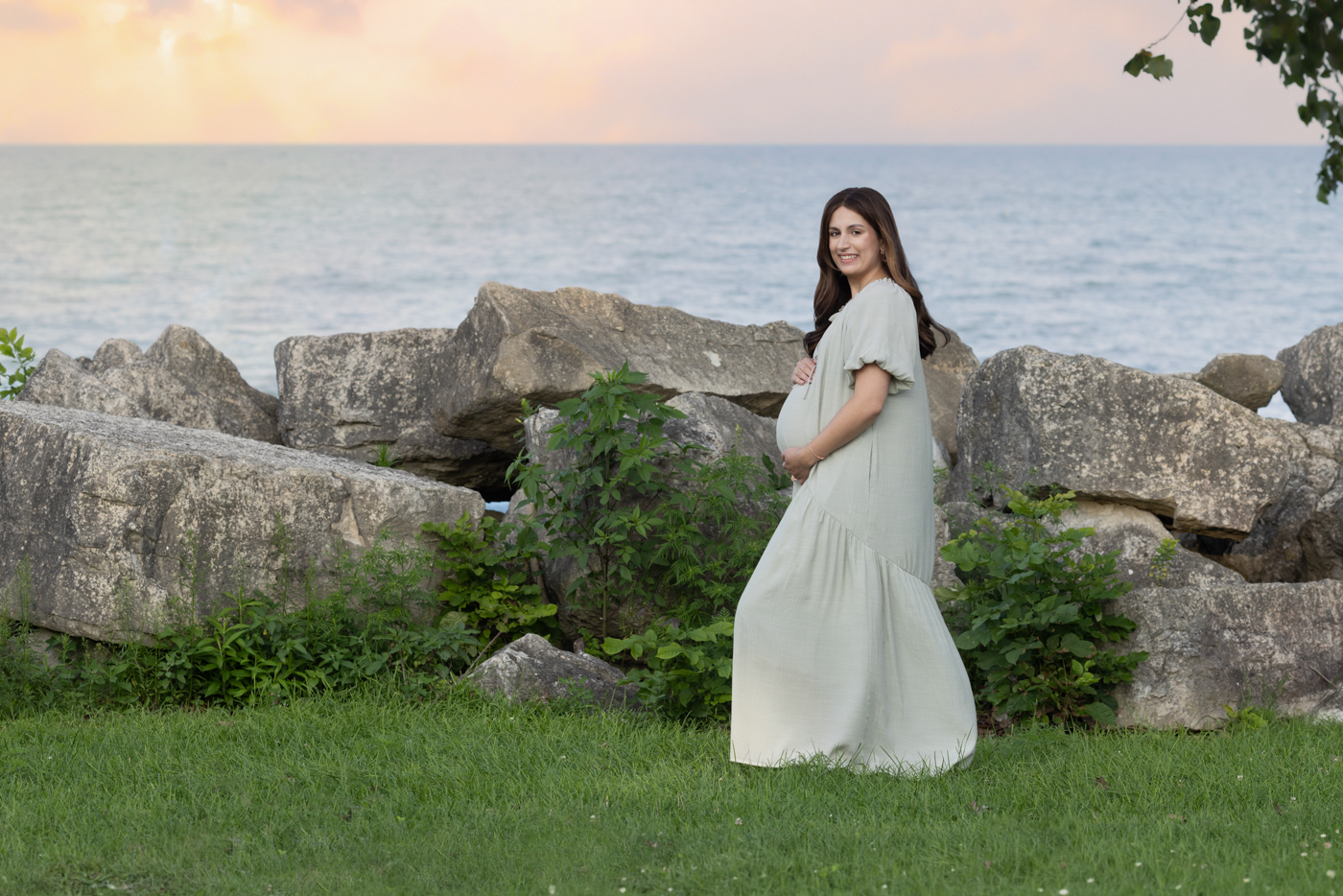 Mom posed at a Lake Michigan Maternity session near the rocks